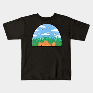 Ginger cat playing in the grass Kids T-Shirt